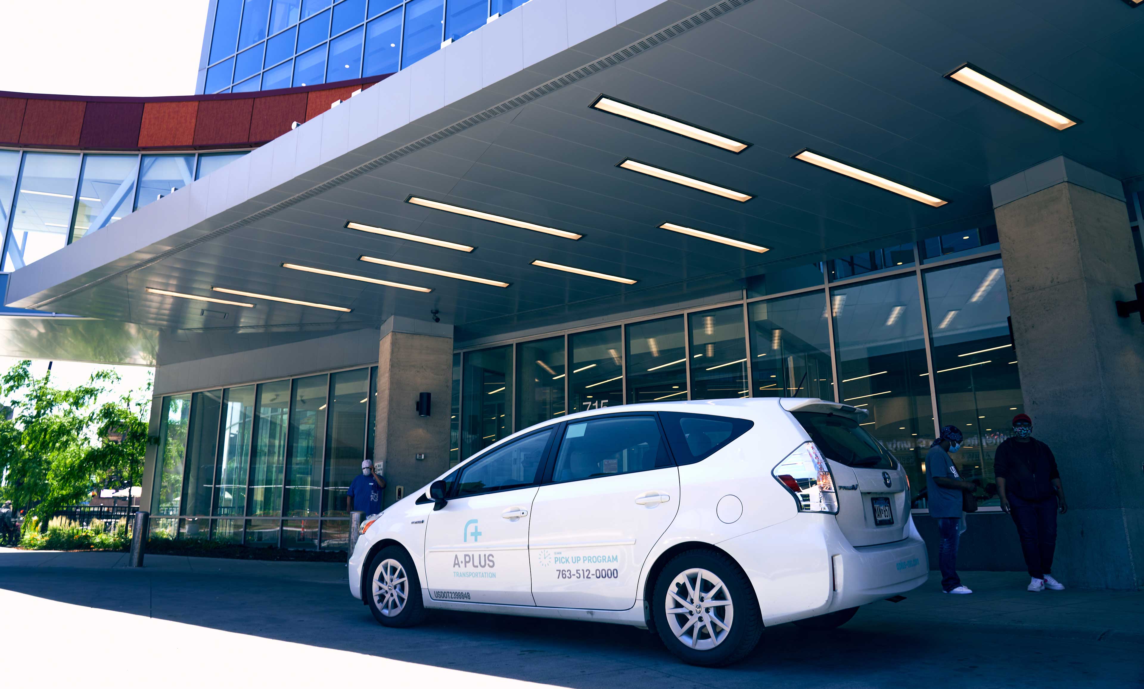 An A-Plus vehicle in front of a medical building.