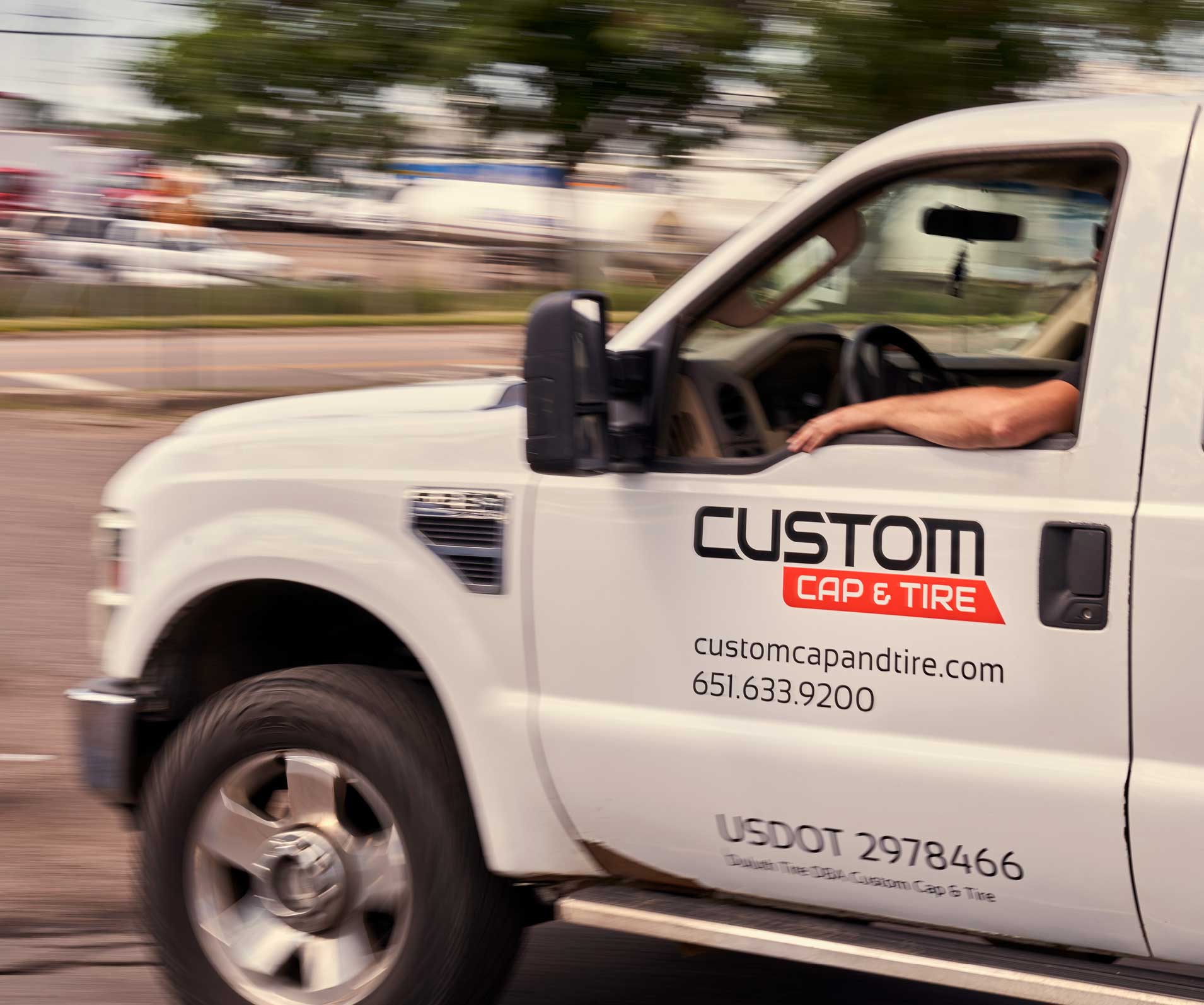 A truck with Custom Cap and Tire decals in motion.