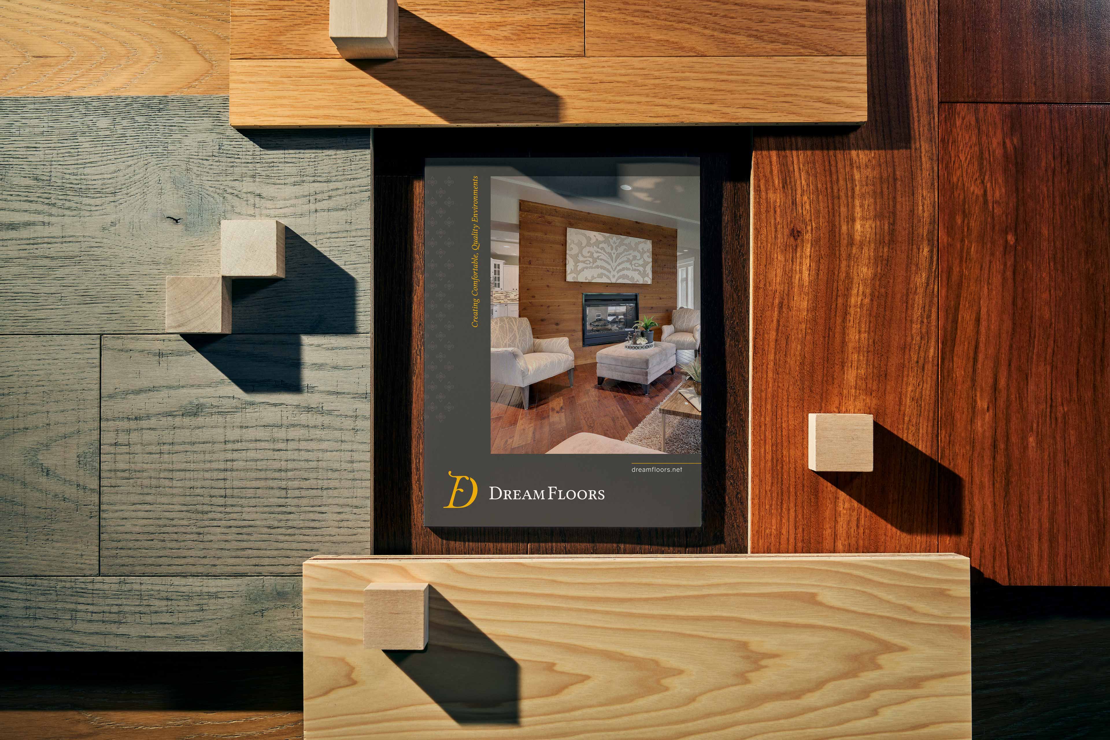 The Dream Floors pocket folder, surrounded by flooring samples.