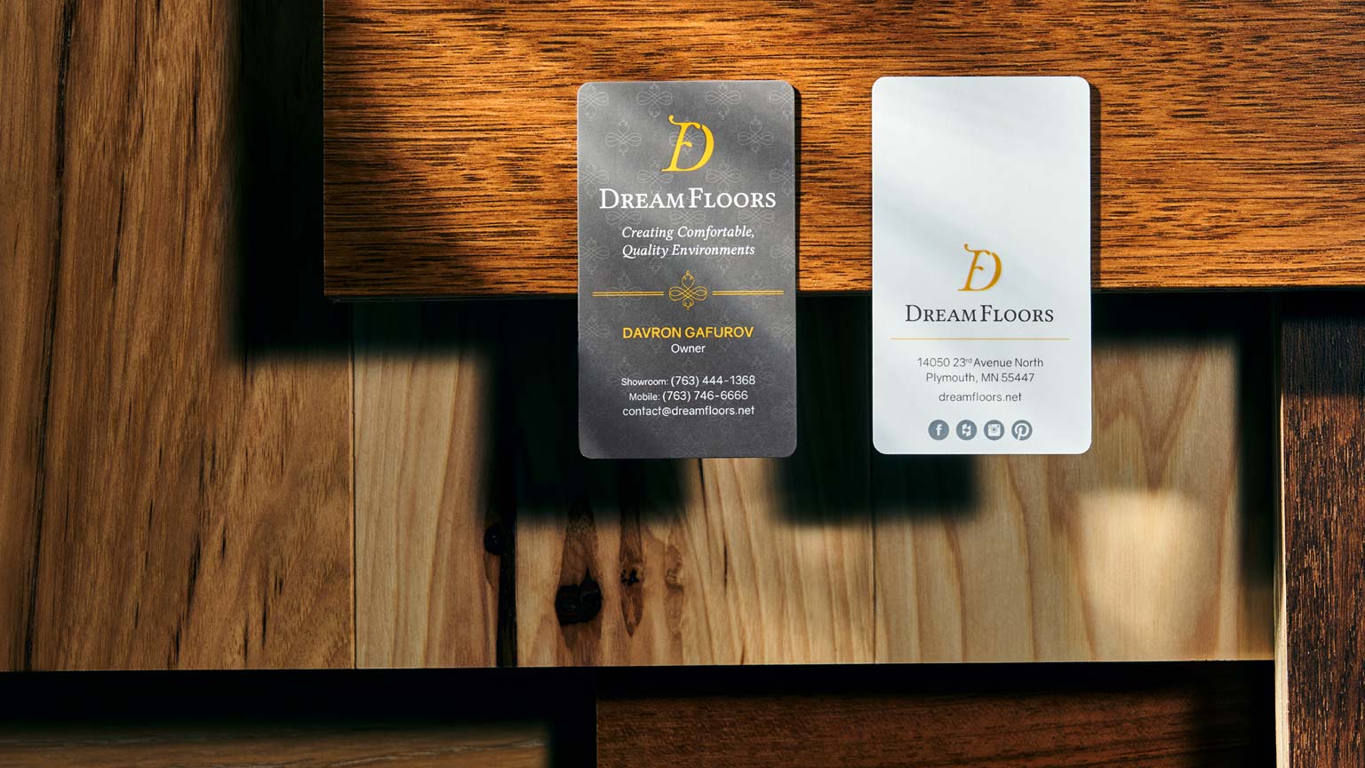 Custom designed business cards for Dream Floors over flooring samples.
